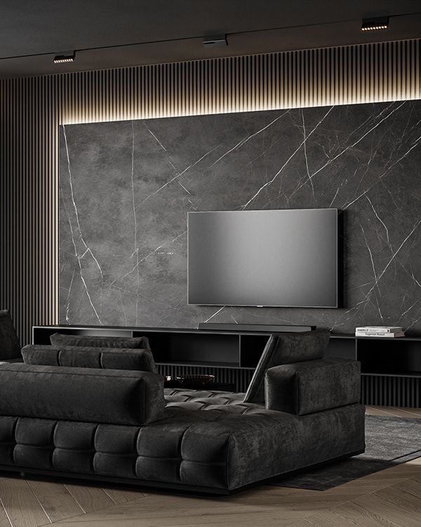 جدار رخام بالمدينة المنورة في وسطه شاشة سوداء وكنبات سوداء