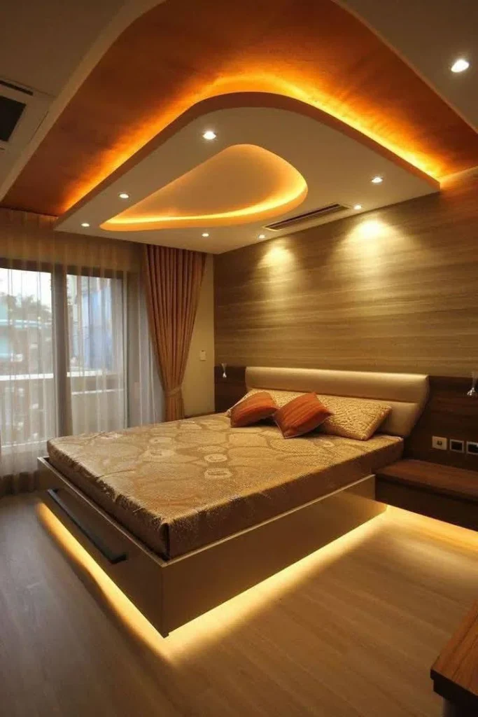 جبس بورد معاصر فوق سرير بشكل انسيابي ومضاء بإضاءة صفراء مخفية من مختارات معلم جبس بورد بالمدينة المنورة